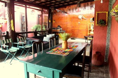 a room with a table with a potted plant on it at Pousada Nova Gironda in Paty do Alferes