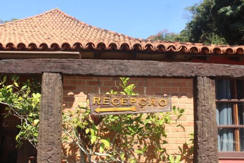 a sign on the side of a building at Pousada Nova Gironda in Paty do Alferes