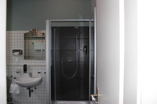 a bathroom with a shower and a sink at Hotel Drei Kronen in Lippstadt