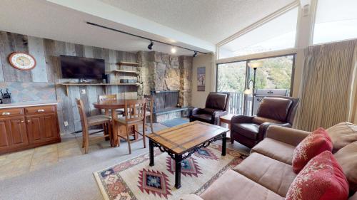 a living room with a couch and a table at Lichenhearth - CoralTree Residence Collection in Snowmass Village