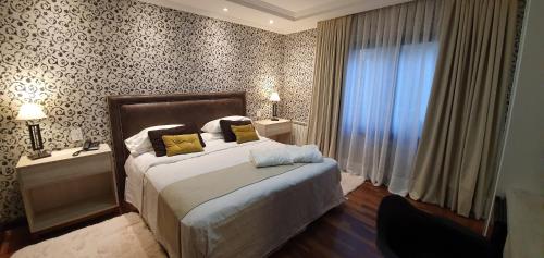 a bedroom with a large bed and a window at MG Design Hotel Boutique in Salta