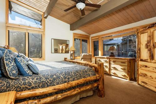 a bedroom with a bed and a desk and windows at Aspenwood - CoralTree Residence Collection in Snowmass Village