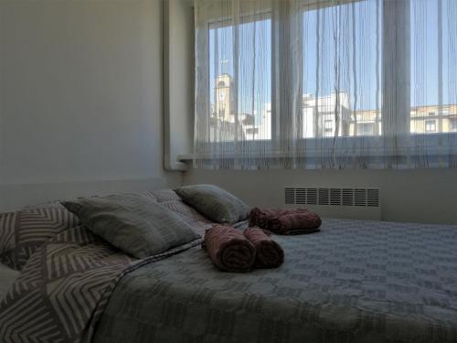 a bed with two pillows on it in a bedroom at Ruby room in Zagreb