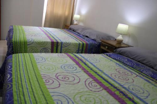 a hotel room with two beds in a room at Hostal Libertad in Masaya