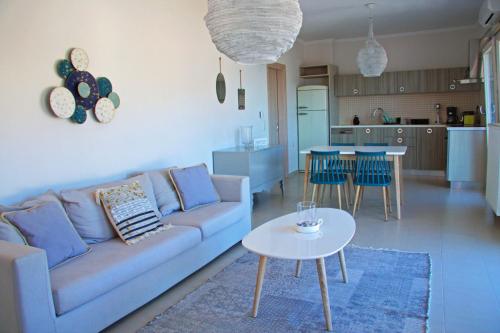 a living room with a couch and a table at Bluevibes in Parga