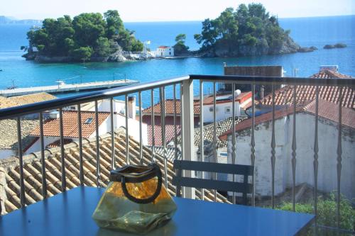 a glass vase sitting on a table on a balcony at Bluevibes in Parga