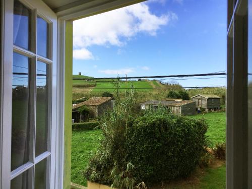 a window view of a field from a house at Villa Várzea Design Nest in Várzea