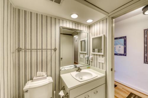 a bathroom with a sink and a toilet and a mirror at 1378 Pelican Watch Villa in Seabrook Island