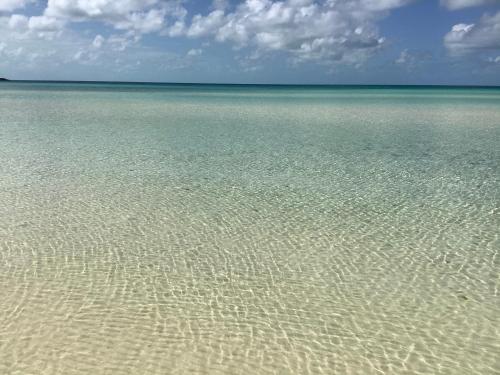 a large body of water with ripples in the sand at Ocean Tally in Upper Bogue