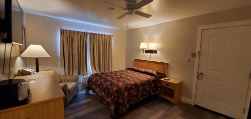 a hotel room with a bed and a couch at Bridge Street Inn in Baker City
