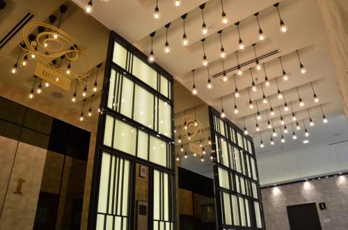 a room with a bunch of lights hanging from the ceiling at SEM9 Senai "Formerly Known As Perth Hotel" in Kulai