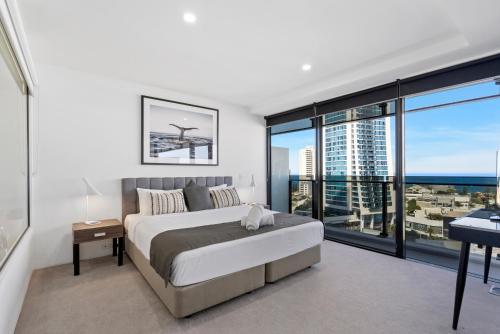 a bedroom with a bed and a view of the ocean at Circle on Cavill - Gclr in Gold Coast