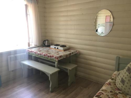 a small room with a table and a mirror at Guest House Muhtuya in Sarma