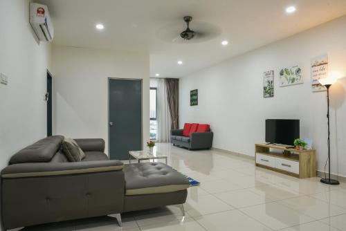 a living room with a couch and a tv at DaMen Homestay @SubangHomeStay in Subang Jaya