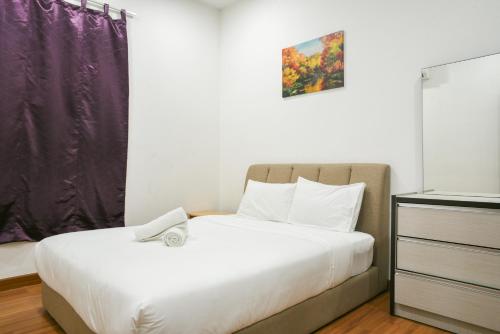 a small bedroom with a bed and a dresser with at DaMen Homestay @SubangHomeStay in Subang Jaya