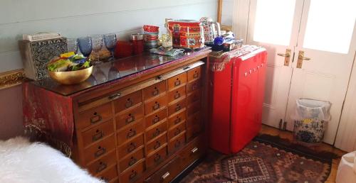 a room with a chest of drawers and a red refrigerator at Chinoiserie - Blue Mountains Boho Luxe in Katoomba