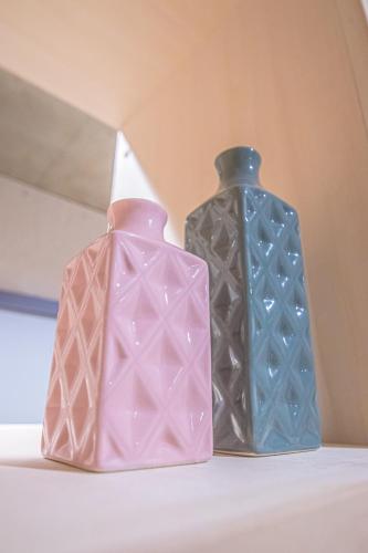 three vases sitting on top of a shelf at AMP FLAT Nishijin 2 in Fukuoka