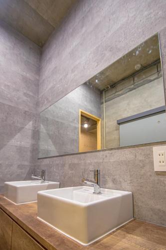a bathroom with two sinks and a mirror at AMP FLAT Nishijin 2 in Fukuoka