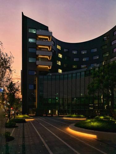 a large building with a street in front of it at Hotel Indigo Taipei North by IHG in Taipei