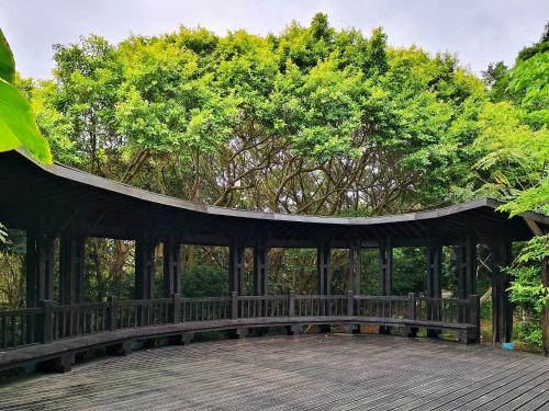 a gazebo with a roof with trees in the background at Hotel Indigo Taipei North by IHG in Taipei