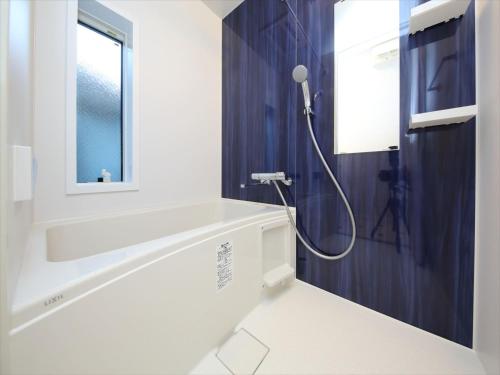 a bathroom with a bath tub and a sink at COTO Tokyo Shibuya 7 in Tokyo