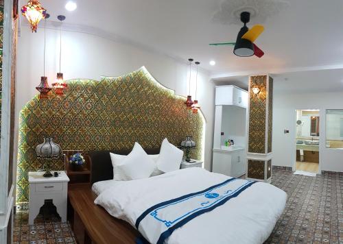 a bedroom with a large bed with a large headboard at Khách sạn Trung Kiên in Hai Phong