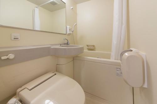 małą łazienkę z toaletą i umywalką w obiekcie Hotel Econo Kameyama w mieście Kameyama