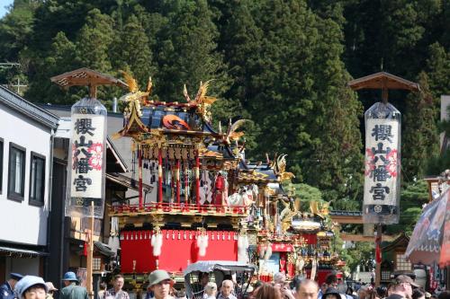 a crowd of people walking in front of a carnival at Private House HidaTakayama in Takayama