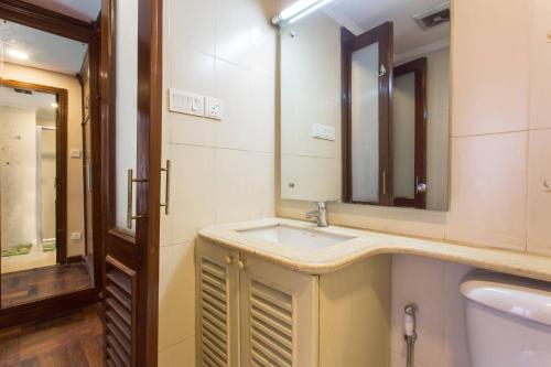 a bathroom with a sink and a mirror at Swayambhu Hotels & Apartments- Sitapaila in Kathmandu