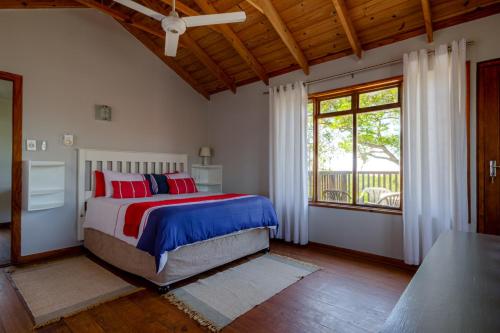 Un dormitorio con una cama y una ventana grande. en St. Lucia Ocean View Holiday Home, en St Lucia