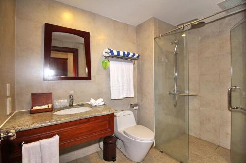 a bathroom with a toilet and a sink and a shower at Novela Muine Resort & Spa in Mui Ne