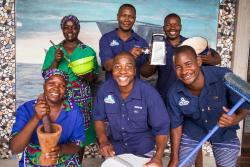 a group of men in blue shirts posing for a picture at Vila Do Paraiso in Vilanculos