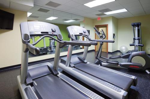 a gym with several tread machines in a room at Country Inn & Suites by Radisson, Sioux Falls, SD in Sioux Falls