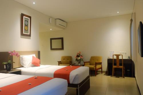 Tempat tidur dalam kamar di Mutiara Hotel and Convention