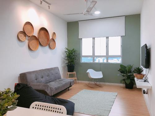 a living room with a couch and a tv at SENJA Homes in Kuala Terengganu
