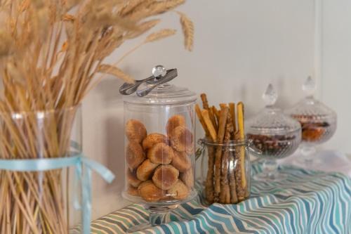a table with a jar filled with cookies and snacks at Nissia Kamares in Kardamaina
