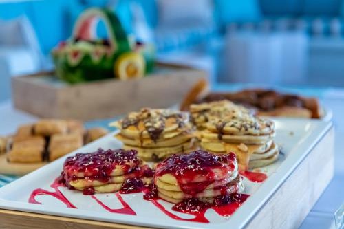 a plate of pancakes and other pastries on a table at Nissia Kamares in Kardamaina