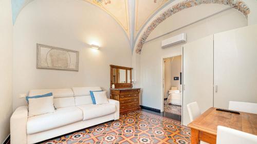 a living room with a white couch and a table at oltremare soul houses in Chiavari