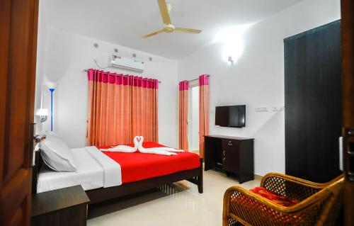 a bedroom with a bed with a swan on it at Snehatheeram Homestay in Alleppey