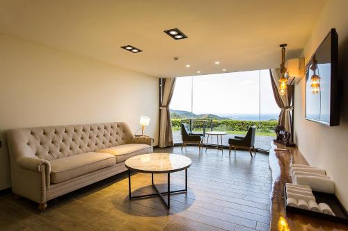 a living room with a couch and a table at Fu Yuan Tan Villa in Fuyuan
