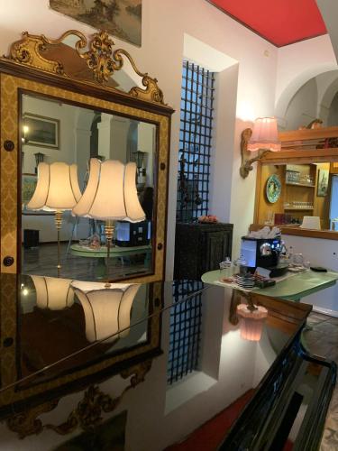 a room with a mirror and a table with a lamp at Hotel Ficocle in Cervia