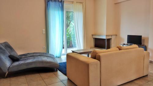 a living room with a couch and a chair at Agroktima Fourki in Aígio