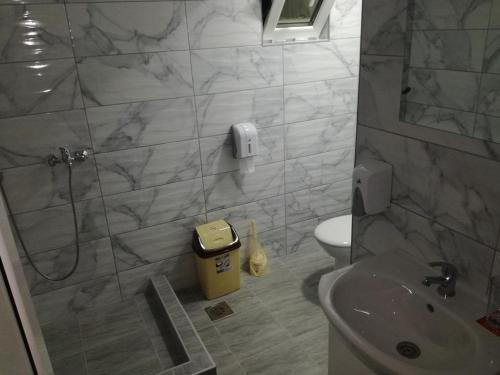 a bathroom with a shower and a toilet and a sink at Hostel „Ж" in Gradsko