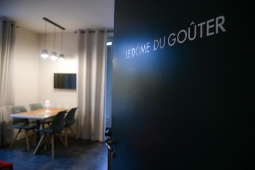 a dining room with a table and a sign on a door at Appart'Hotel Aiguille Verte & Spa in Chamonix-Mont-Blanc