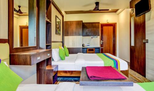 a bedroom with two beds and a desk at Itsy Hotels The Villa Retreat in Siliguri