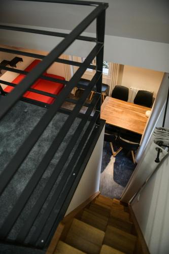 an overhead view of a staircase with a table and chairs at Appart'Hotel Aiguille Verte & Spa in Chamonix-Mont-Blanc