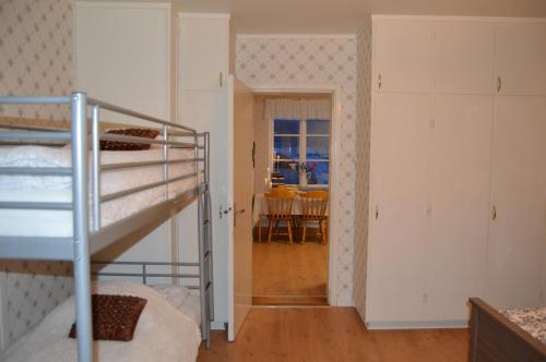 a room with a bunk bed and a dining room at River Lodge in Ludvika