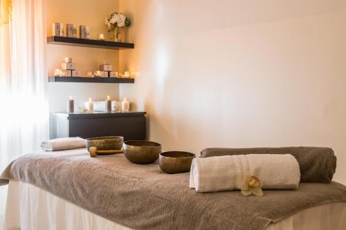 a bed with two bowls and towels on it at Atlantic Terme Natural Spa & Hotel in Abano Terme