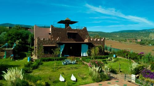 a house with a garden in front of it at Les Jardins Yasmina Bin el-Ouidane in Bine el Ouidane