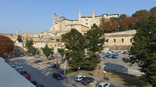 a view of a large building with a parking lot at Balcone sulle Meraviglie in Urbino